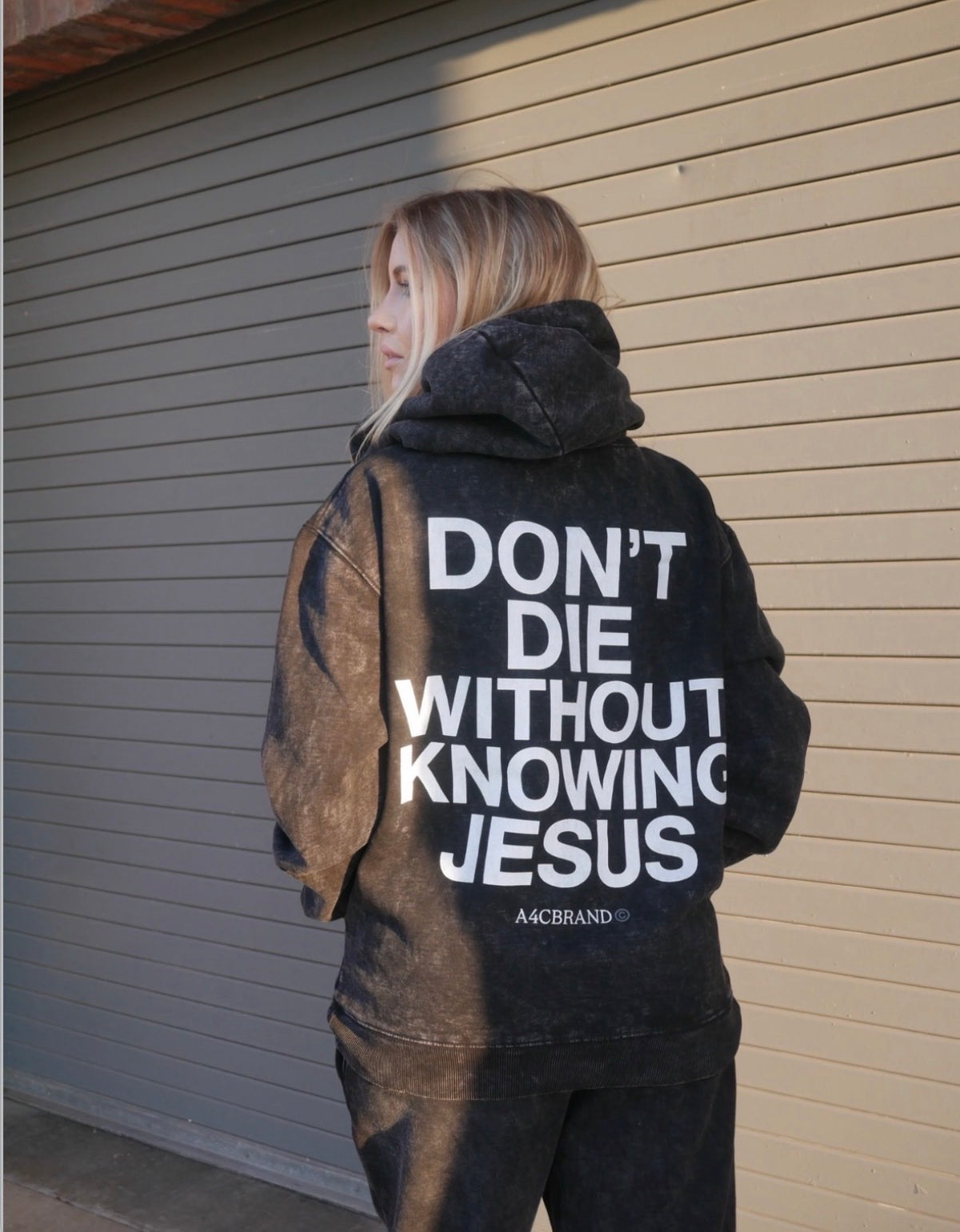 Don't Die Without Knowing Jesus washed black hoodie on model, back print